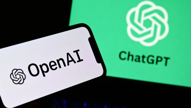 A smartphone and a laptop displaying the logos of the artificial intelligence OpenAI research laboratory and ChatGPT robot. Photo by MARCO BERTORELLO / AFP