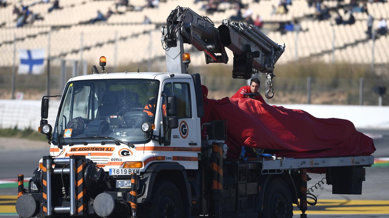 The car of Sebastian Vettel is transported back to the pits after breaking down during day three of testing.