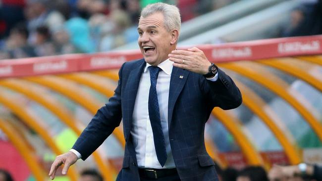 Japan coach Javier Aguirre gestures to his players during the AFC Asia Cup soccer match between Japan and Palestine in Newcastle, Australia, Monday, January 12, 2014. (AP Photo/Rob Griffith)