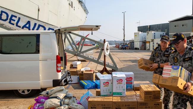 Deputy Maritime Logistics Officer Lieutenant Fred Bates and Assistant Maritime Logistics Officer and Lieutenant Roger Jolly prepare supplies. Picture: AAP/Supplied by the Department of Defence, Leo Baumgartner