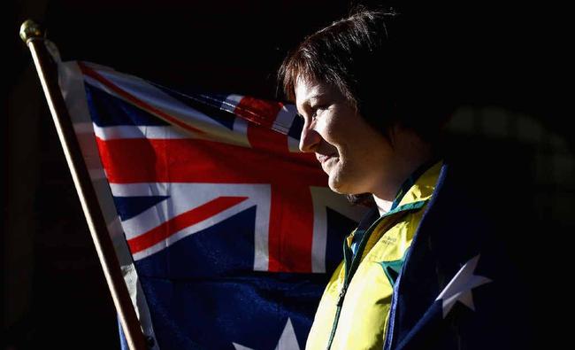 Anna Meares of Australia poses with the Australian flag after she was announced as the flag bearer for the opening ceremony. Picture:  Robert Cianflone/Getty Images