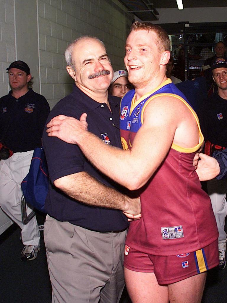 Michael Voss with coach Leigh Matthews celebrate after their Round 10 win over Essendon at the Gabba in 2001.