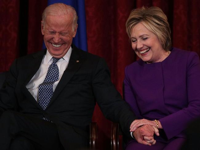Vice President Joseph Biden and Hillary Clinton shares a moment as a portrait of Senate Minority Leader Harry Reid is unveiled on Capitol Hill in Washington DC. Picture: Alex Wong/Getty Images/AFP