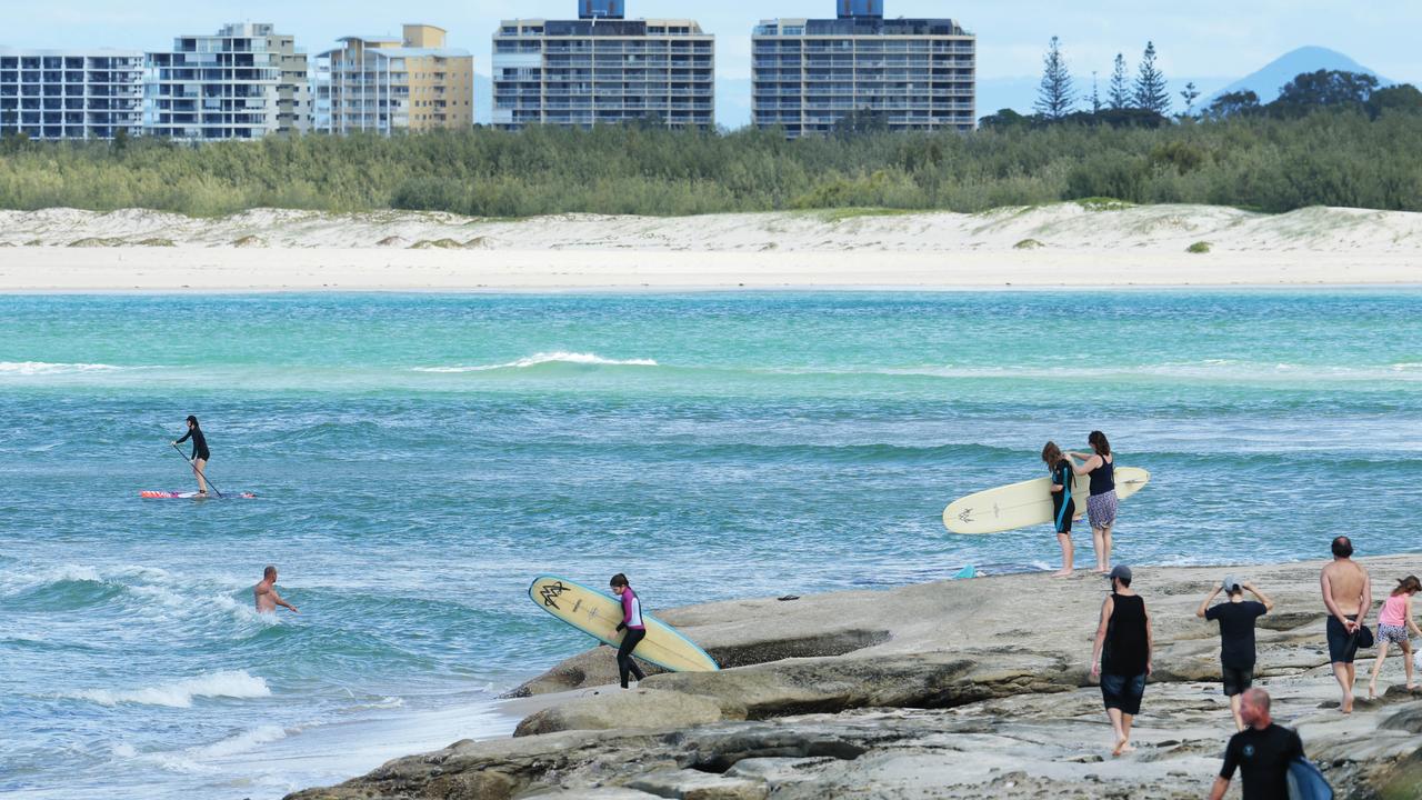 Surfers on the headland at Happy Valley in Caloundra. Photo Lachie Milllard