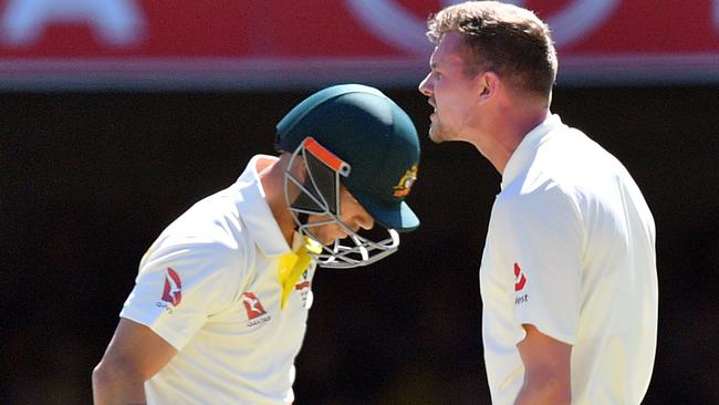 England bowler Jake Ball, right, celebrates after taking the wicket David Warner, left. Picture: AP.