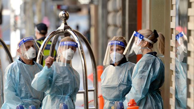 MELBOURNE, AUSTRALIA - NewsWire Photos AUGUST 23, 2021: Medical staff wait at the Novotel Collins Street for the first bus load of passengers evacuated from the Afghani capital Kabul.. Picture: NCA NewsWire / Andrew Henshaw