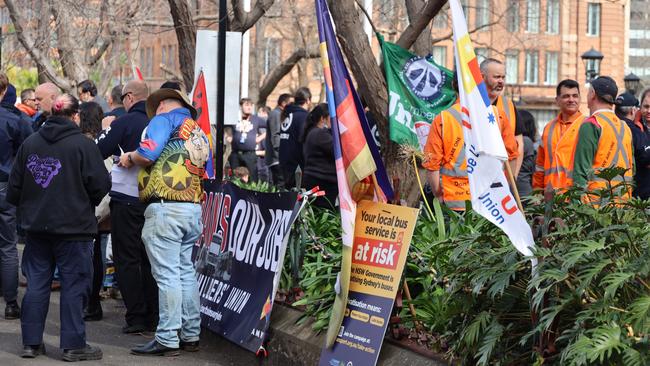 Bright coloured banners and flags surrounded the group outside Central Station. Picture: NCA NewsWire / Nicholas Eagar