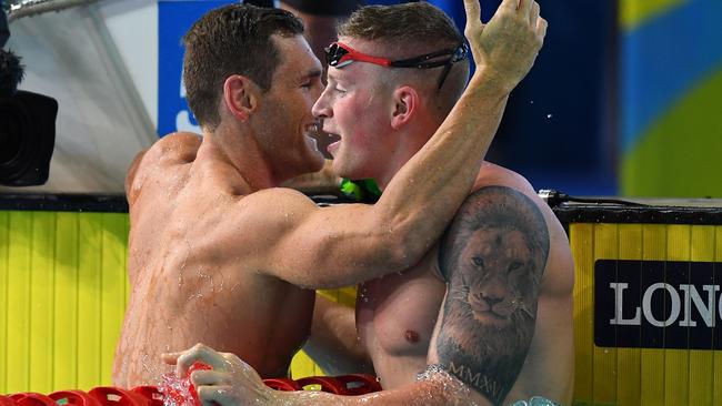 South African gold medallist Cameron van der Burgh (L) hugs England's Adam Peaty after the 50m breaststroke. Photo: AFP