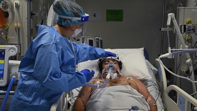 An ICU nurse cares for a Covid-19 positive patient. Photo: Kate Geraghty