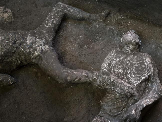 This undated photo handout on November 21, 2020 by the Pompeii Archaeological Park shows casts of the bodies of two men, a 40-year-old master and his young slave, after they were found during recent excavations of a Villa in Civita Giuliana in the outskirts of Pompeii, as Park officials said conditions were optimal to get casts of the victims, following the technique perfected in 1863 by Giuseppe Fiorelli. - The ancient Roman city of Pompeii was engulfed under a hail of volcanic ash after nearby Mount Vesuvius erupted in the year 79. Vesuvius' eruption covered the in a toxic, metres-thick layer of volcanic ash, gases and lava flow which then turned to stone, encasing the city, allowing an extraordinary degree of frozen-in-time preservation both of city structures and of residents unable to flee. (Photo by Handout / POMPEI ARCHAEOLOGICAL PARK / AFP) / RESTRICTED TO EDITORIAL USE - MANDATORY CREDIT "AFP PHOTO / POMPEII ARCHAEOLOGICAL PARK / LUIGI SPINA" - NO MARKETING - NO ADVERTISING CAMPAIGNS - DISTRIBUTED AS A SERVICE TO CLIENTS