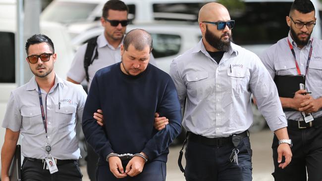 Ebrahim Qasimi is led into Hornsby Court by four guards. Picture: John Grainger