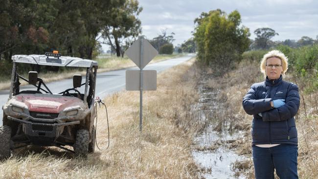 Natalie Akers on the roadside outside her family's dairy farm spraying weeds. Picture: Zoe Phillips