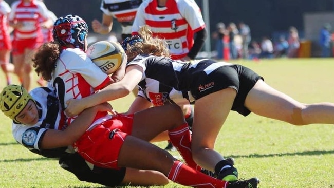 TOUGH TACKLING: Lismore Rugby Union Club Kali Ainsworth, 15, (far left) shows her grit dung for a game for Mind-North Coast U16 Girls team in Kiama ahead of being selected for the NSW Country U16 squad.