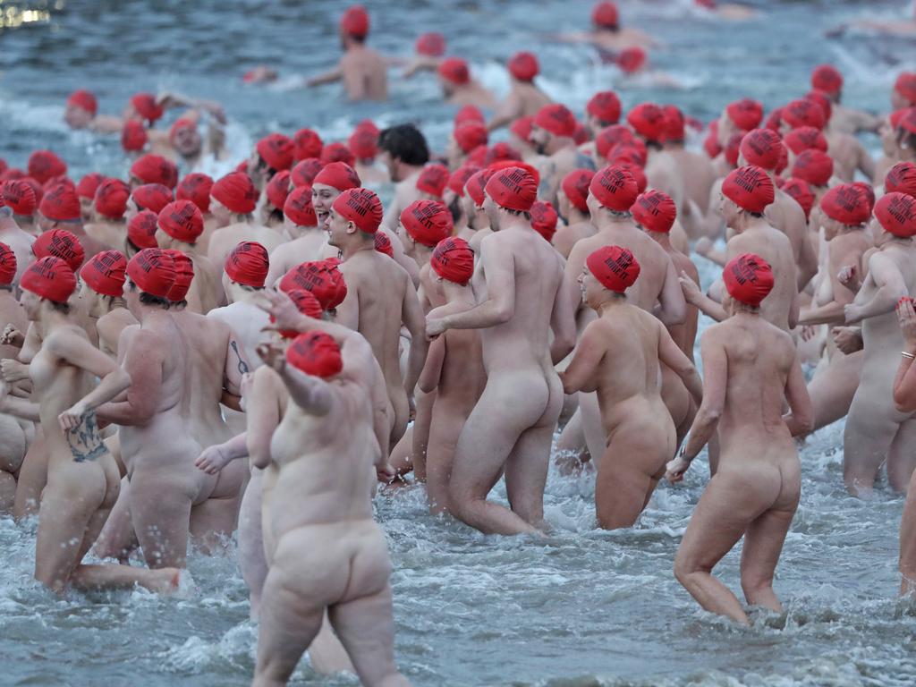 DARK MOFO 2019: Participants of the nude solstice swim brave the cold water at dawn at Long Beach, Sandy Bay. Picture: LUKE BOWDEN