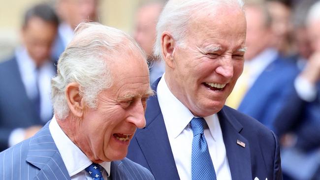 US President Joe Biden laughs as he walks with King Charles III during a ceremonial welcome in the Quadrangle at Windsor Castle. Picture: AFP