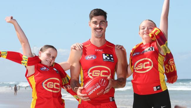 Primed for a big weekend of sport for the Gold Coast Suns are player Alex Sexton and fans Kayla Smith and Bonnie Stott.. Picture Glenn Hampson