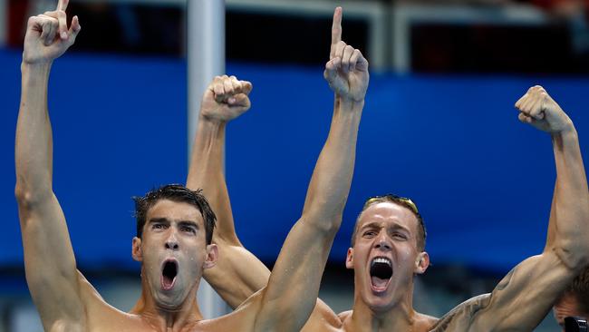 Michael Phelps and Caeleb Dressel of the United States celebrate winning gold.