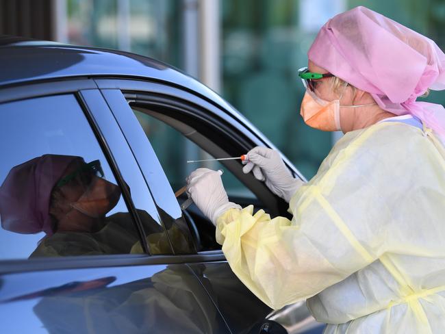 Nurse Shirley Molloy swabs a patient for COVID-19 at a drive-through Fever Clinic in Caloundra on the Sunshine Coast, Thursday, April 30, 2020. The Queensland Government has announced that some restrictions will be eased in Queensland due to a very low number of new COVID-19 infections from Saturday, May 2. Queenslanders will be able to go for a drive (within 50km of home), ride a motorbike, jetski or boat for recreation, have a picnic, visit a national park and shop for non-essential items. (AAP Image/Dan Peled) NO ARCHIVING