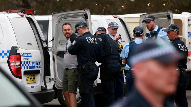 A protestor is taken away by police. Toby Zerna