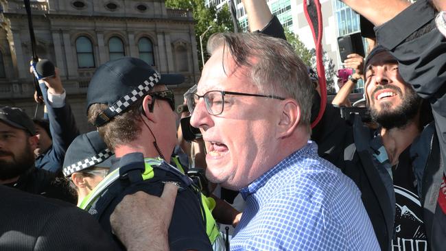 A man yells abuse at Cardinal George Pell as he enters County Court in Melbourne. Picture: AAP Image/David Crosling