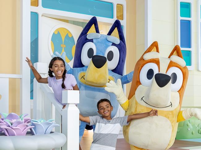 **UNDER EMBARGO UNTIL SUNDAY 13 OCTOBER** The first glimpse of Bluey's World Brisbane as fans eagerly await the opening next month. Pictured is Madeleine Evans, 10, and Joshua Evans, 7, with Bingo and Bluey. Photo: Supplied.