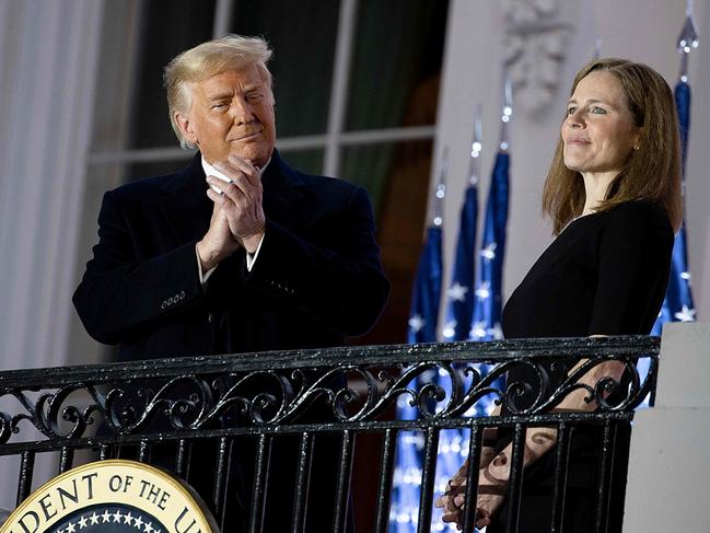 TOPSHOT - WASHINGTON, DC - OCTOBER 26: U.S. President Donald Trump stands with newly sworn in U.S. Supreme Court Associate Justice Amy Coney Barrett during a ceremonial swearing-in event on the South Lawn of the White House October 26, 2020 in Washington, DC. The Senate confirmed Barrettâs nomination to the Supreme Court today by a vote of 52-48.   Tasos Katopodis/Getty Images/AFP (Photo by TASOS KATOPODIS / GETTY IMAGES NORTH AMERICA / AFP)