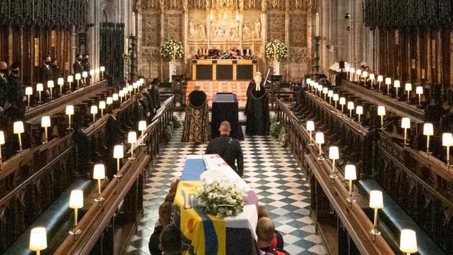 The coffin is carried into The Quire during the funeral service of Britain's Prince Philip, Duke of Edinburgh at St George's Chapel at Windsor Castle, Windsor, west of London, on April 17, 2021. - Philip, who was married to Queen Elizabeth II for 73 years, died on April 9 aged 99 just weeks after a month-long stay in hospital for treatment to a heart condition and an infection. (Photo by Barnaby Fowler / POOL / AFP)