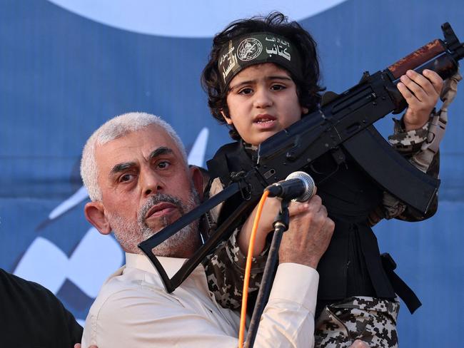 Hamas leader Yahya Sinwar holds the child of an Al-Qassam Brigades fighter. Picture: AFP