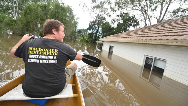 A resident sees his his totally swamped home in Oxley for the first time after floods and rain swamped Brisbane. Pic Lyndon Mechielsen/The Australian