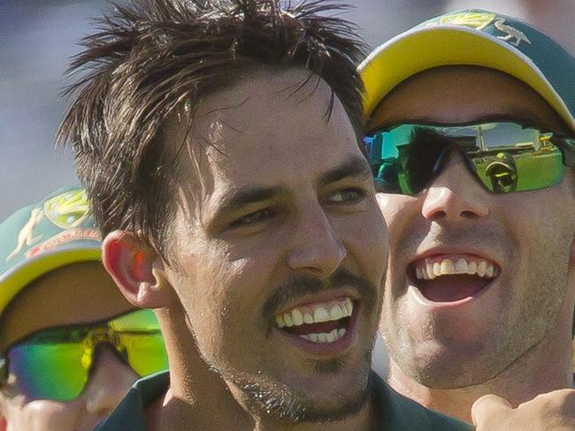 Australian bowler Mitchell Johnson (C) celebrates with teammates after taking the wicket of England batsman England batsman Eoin Morgan during the tri-series one-day cricket final between England and Australia at the WACA in Perth on February 1, 2015.   AFP PHOTO / TONY ASHBY RESTRICTED TO EDITORIAL USE - STRICTLY NO COMMERCIAL USE