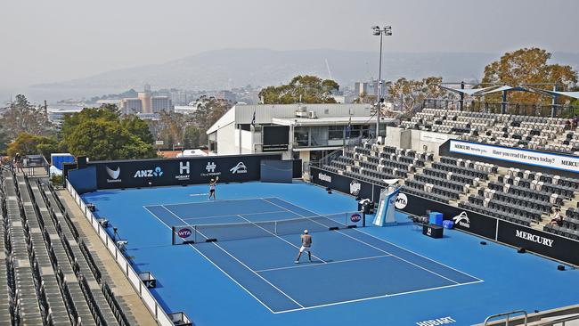 A tennis player competing at the Hobart International training in the smoky conditions. Picture: ZAK SIMMONDS