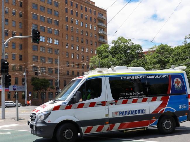 MELBOURNE, AUSTRALIA - NewsWire Photos 18 JANUARY 2022 : VictoriaÃs hospital system is under extreme pressure due to the covid-19 Omicron variant and a ÃCode brownÃ has been enforced.This will enable hospitals to cancel their staffs leave to ensure an adequate workforce is on hand. An ambulance passes St VincentÃs Hospital. Picture : NCA NewsWire / Ian Currie