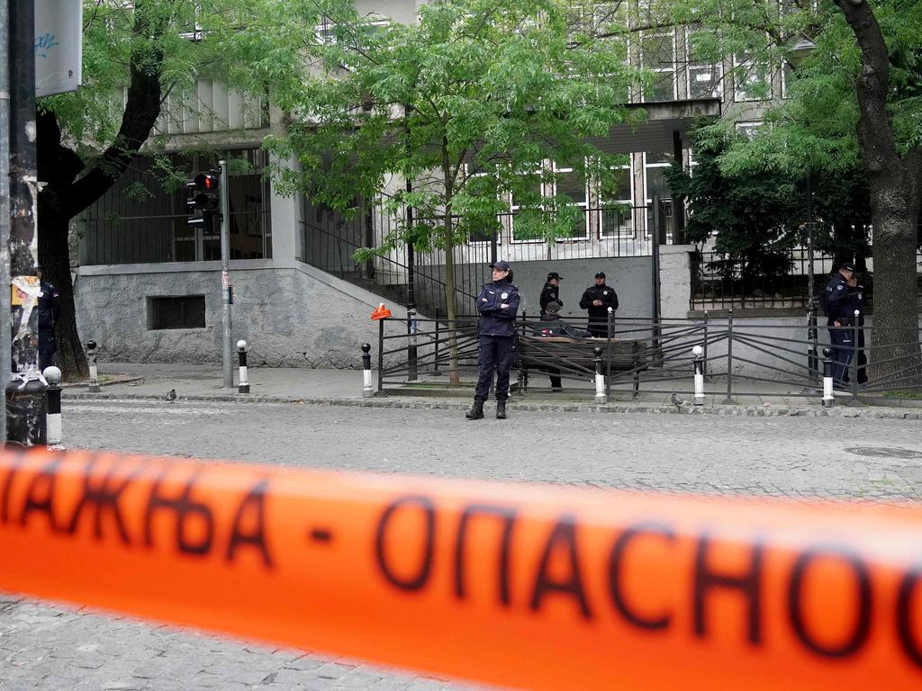 Police officers guard the school entrance following a shooting at a school in Belgrade on May 3, 2023. (Photo by Oliver Bunic / AFP)