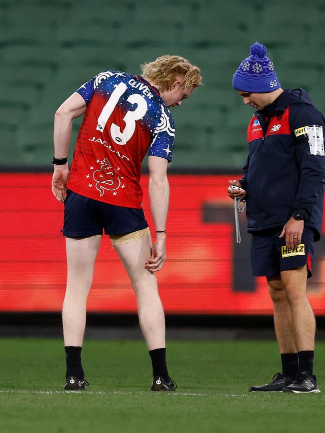 Clayton Oliver of the Demons speaks with medical staff about his injured hamstring. (Photo by Michael Willson/AFL Photos via Getty Images)