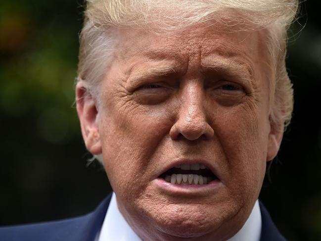 (FILES) In this file photo former US President Donald Trump speaks to the press as he departs the White House in Washington, DC, on August 6, 2020. - Former US president Donald Trump stole the spotlight at a wedding in his Mar-a-Lago resort in Florida over the weekend, using a congratulatory speech to mainly talk about himself and assail his successor. "Do you miss me yet?" a tuxedo-clad Trump asked at the March 27, 2021 function, according to video posted on celebrity gossip site TMZ. His question was met with whoops of delight and applause from guests at the wedding, between longtime Trump friends Megan Noderer and John Arrigo, according to Business Insider. (Photo by Olivier DOULIERY / AFP)