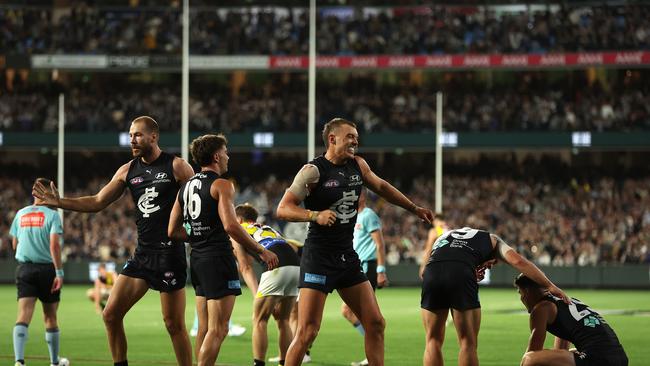 MELBOURNE, AUSTRALIA - MARCH 14: The Blues celebrate after they defeated the Tigers during the round one AFL match between Carlton Blues and Richmond Tigers at the Melbourne Cricket Ground, on March 14, 2024, in Melbourne, Australia. (Photo by Robert Cianflone/Getty Images)