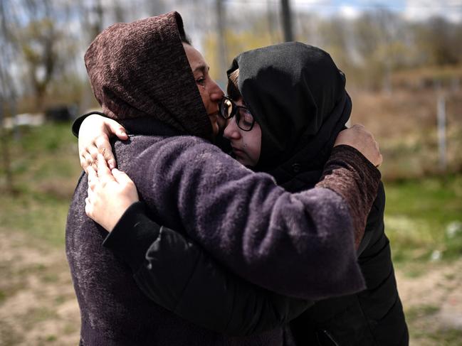 Ukrainian refugees embrace after reuniting on their way back to Ukraine along the Ukrainian-Moldovan border at the Palanca border crossing. Picture: AFP