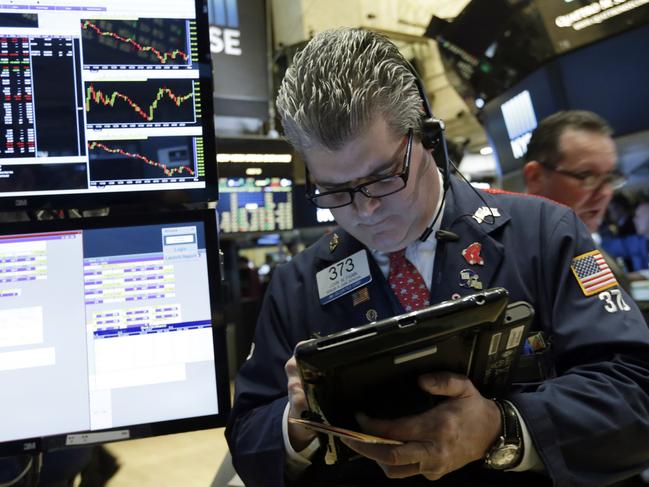 Trader John Panin works on the floor of the New York Stock Exchange, Thursday, Jan. 14, 2016. U.S. stocks moved slightly lower in early trading Thursday, extending losses following the worst market drop since September. Investors had their eye on the latest company earnings and outlooks. Consumer discretionary stocks were among the biggest decliners. (AP Photo/Richard Drew)