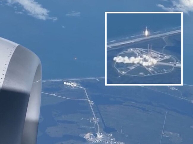 Passengers on a plane have watch a rocket launch.