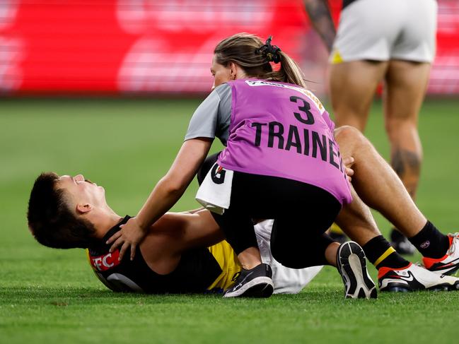 Josh Gibcus with medical staff during the Round 1 match at the MCG. Picture: Dylan Burns/AFL Photos via Getty Images.