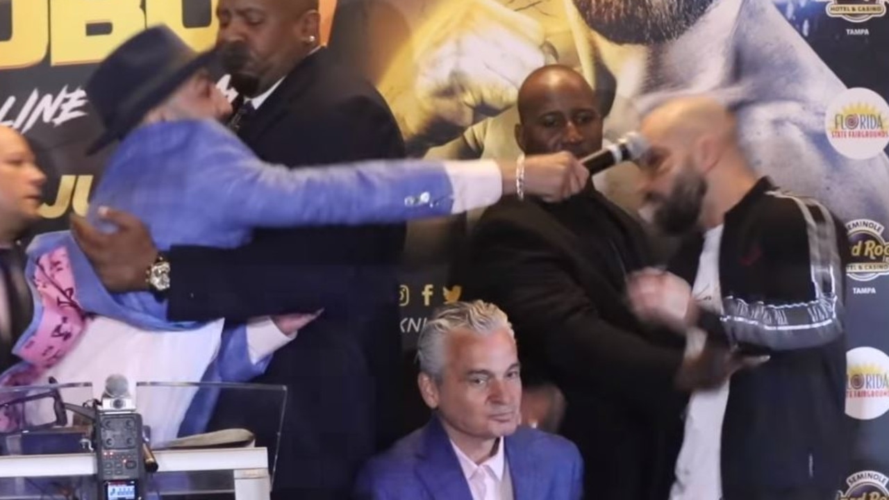 Malignaggi attempts to hit Lobov with a microphone.