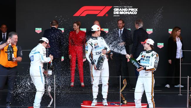 The top three drivers celebrated by spraying champagne on the podium