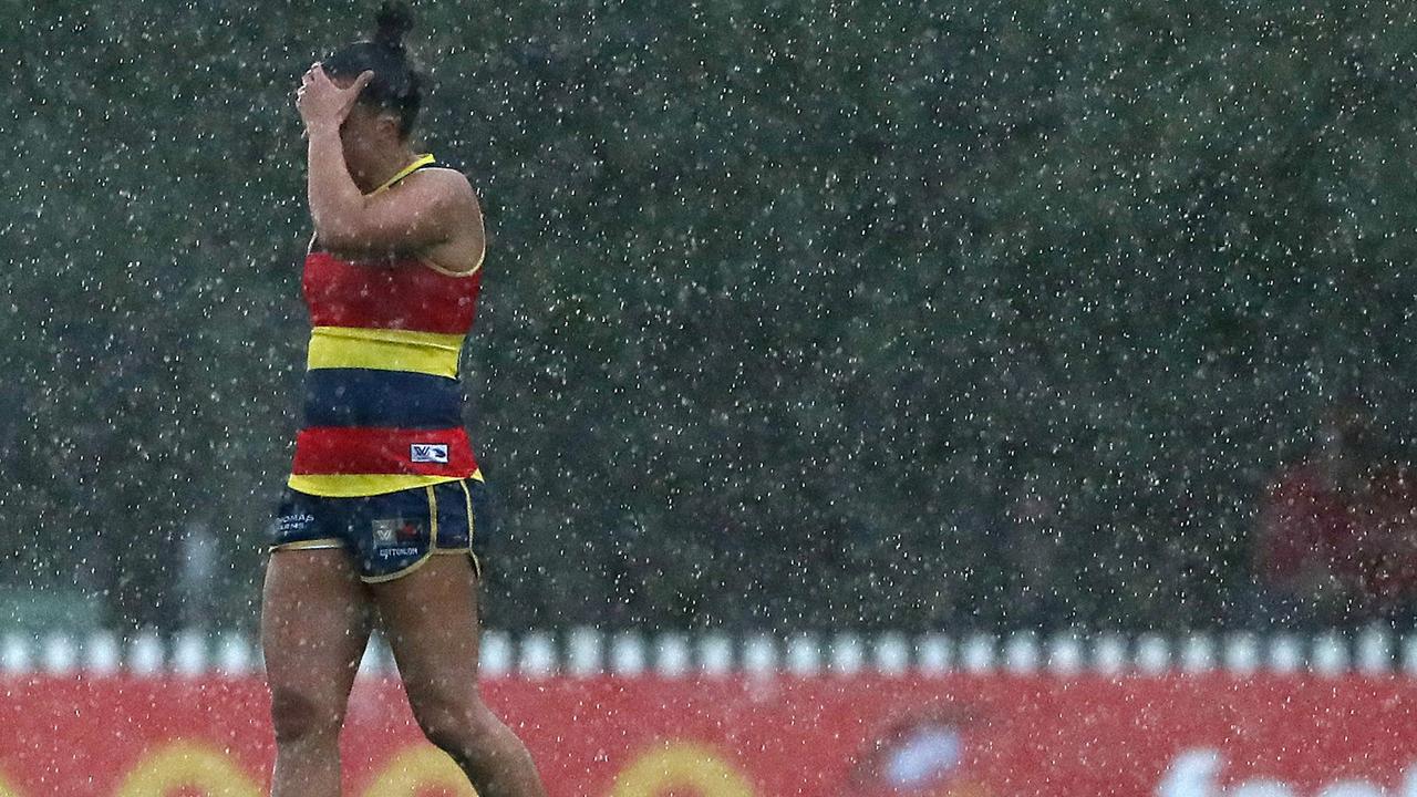 Ebony Marinoff can barely see because of the torrential downpour. Picture: Sarah Reed/AFL Photos via Getty Images