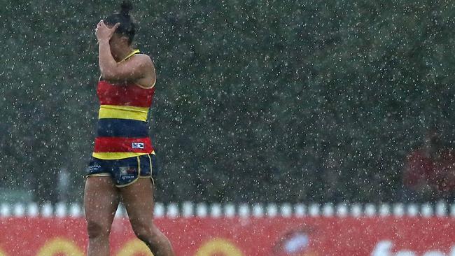 Ebony Marinoff can barely see because of the torrential downpour. Picture: Sarah Reed/AFL Photos via Getty Images