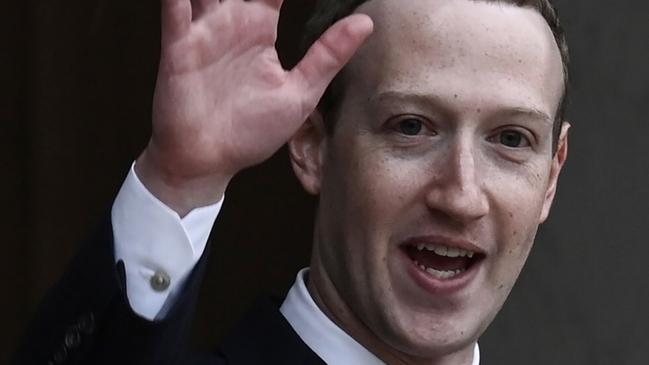 Facebook chief Mark Zuckerberg waves as he leaves the Elysee Palace in Paris after a meeting with the French president. Picture: AFP