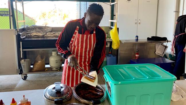 Raiders’ Vianne Kurikwimana, 16, raising money for a trip to Spain with sausage sizzles at Bunnings. Picture: Supplied.