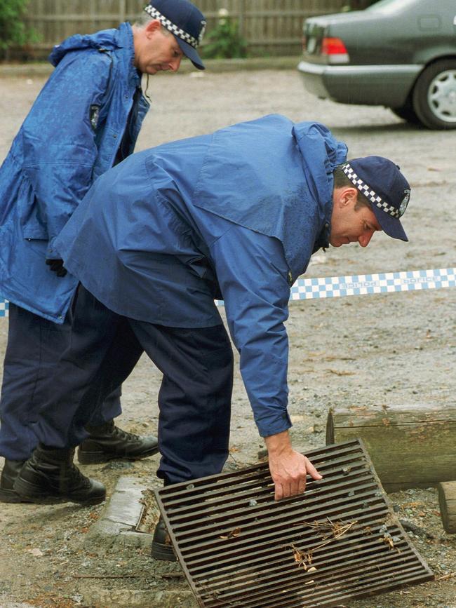 Police search the carpark where Christos Saristavros was shot dead on October 22, 2000.