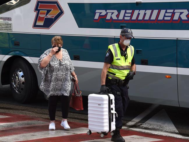 Police remove Karen Warren from a bus at the Queensland border. Picture: Steve Holland/NCA NewsWire