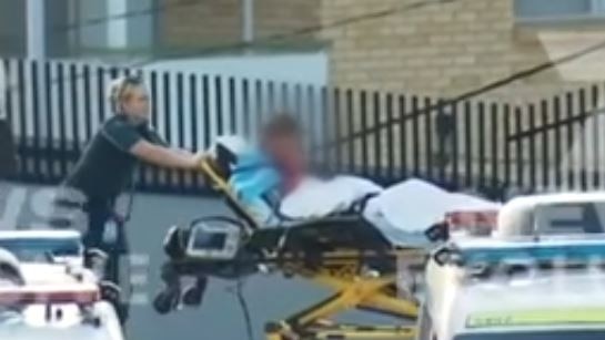 A Coles worker is brought to an ambulance after being stabbed at a supermarket in Ipswich, with a 13-year-old boy later charged with attempted murder over the incident. Picture 7News