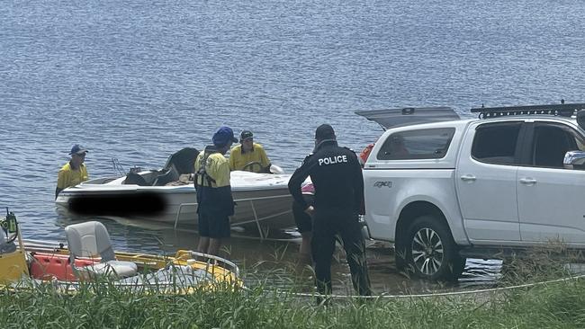 Emergency services bring the family's boat ashore at Kinchant Dam.